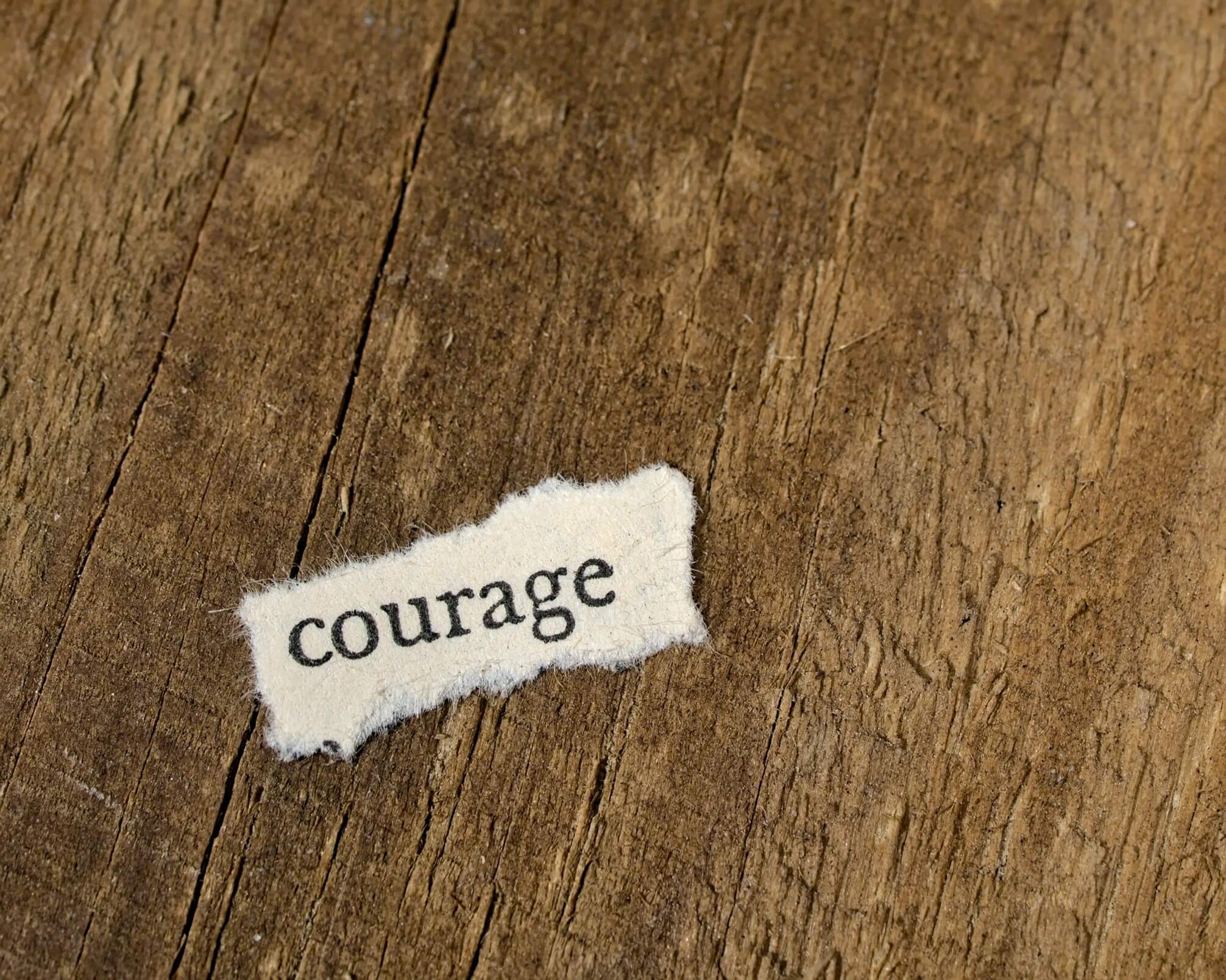 photo of the word courage on a plank of wood